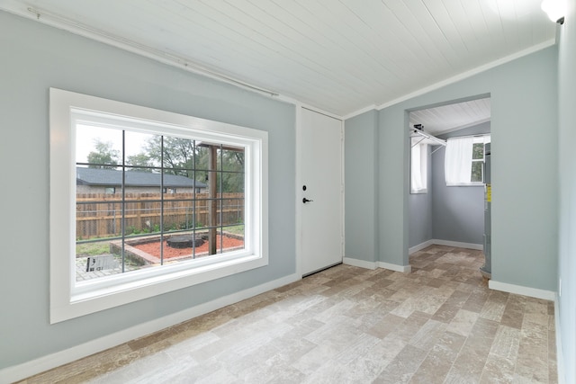 empty room with baseboards, lofted ceiling, ornamental molding, and wooden ceiling