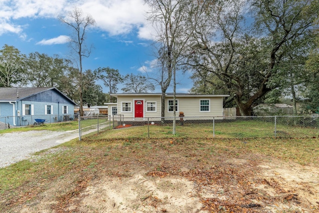 ranch-style house featuring entry steps, a front lawn, and fence private yard