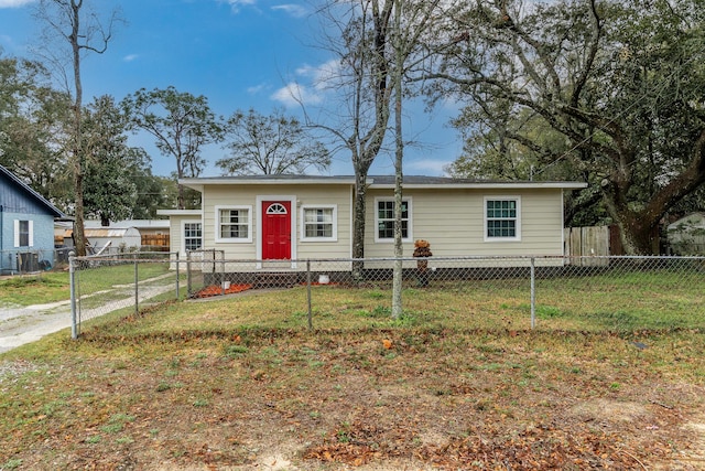 view of front facade with a fenced front yard and a front lawn