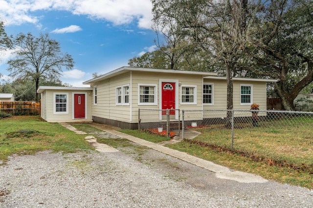 view of front of property featuring a fenced front yard and a front lawn