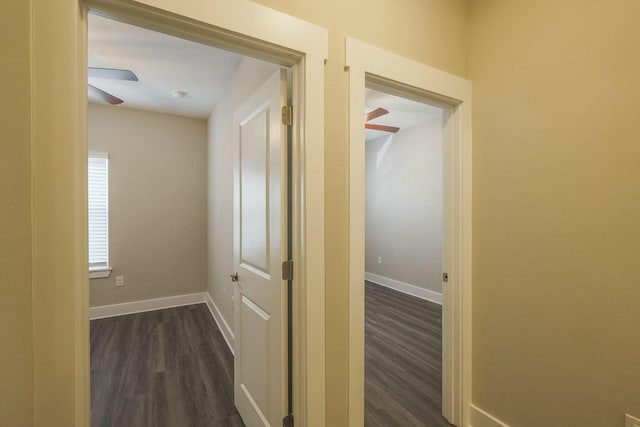 hallway with baseboards and dark wood-style flooring