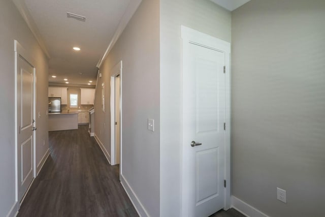 corridor featuring visible vents, recessed lighting, dark wood-type flooring, and baseboards