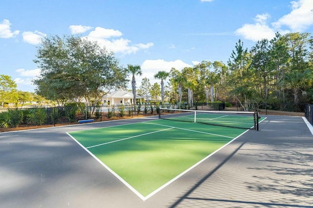 view of sport court featuring fence