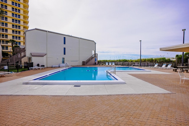 pool featuring a patio and fence