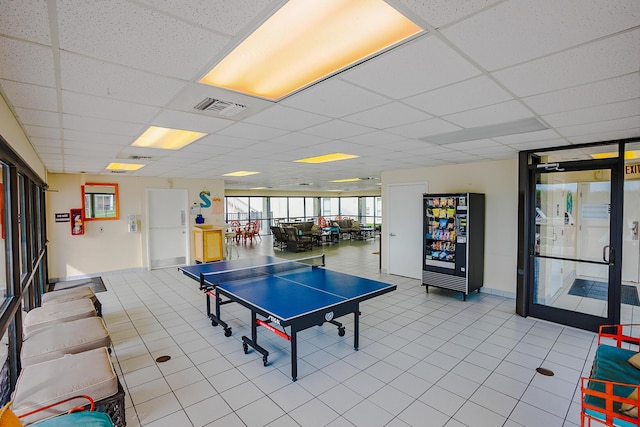 recreation room featuring tile patterned flooring, visible vents, and a paneled ceiling