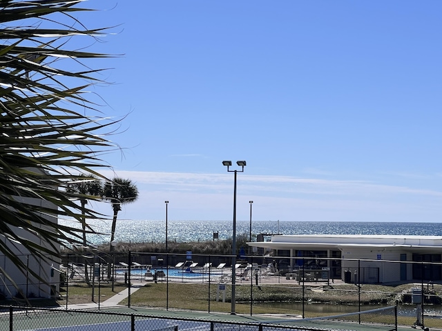 property view of water featuring fence