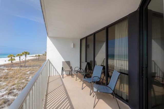 balcony with a beach view and a water view