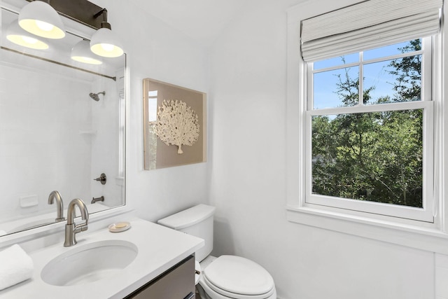 full bathroom with vanity, toilet, and a shower