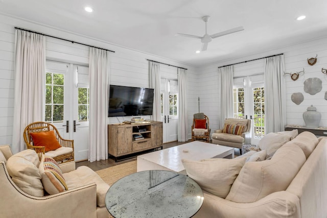 living room featuring plenty of natural light, french doors, a ceiling fan, and wood finished floors