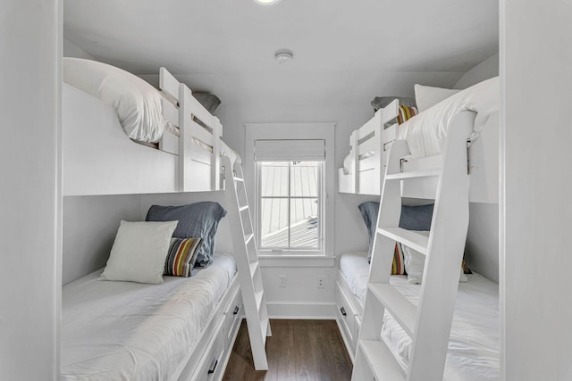 bedroom with baseboards and wood finished floors