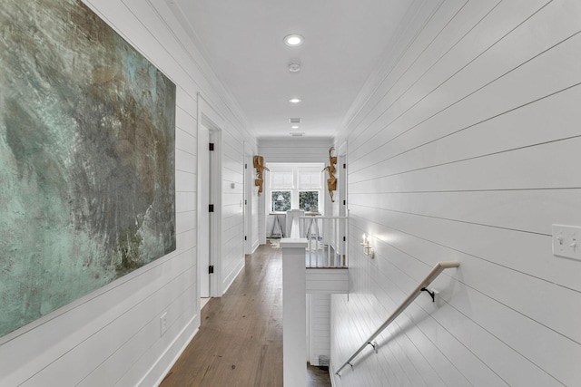 corridor featuring dark wood-style floors, recessed lighting, an upstairs landing, and ornamental molding