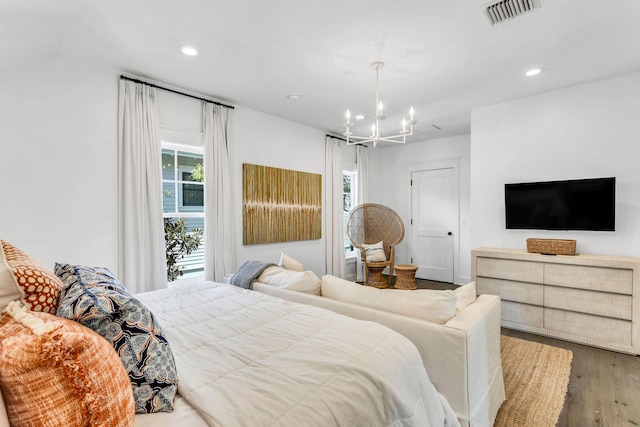 bedroom featuring recessed lighting, visible vents, an inviting chandelier, and wood finished floors