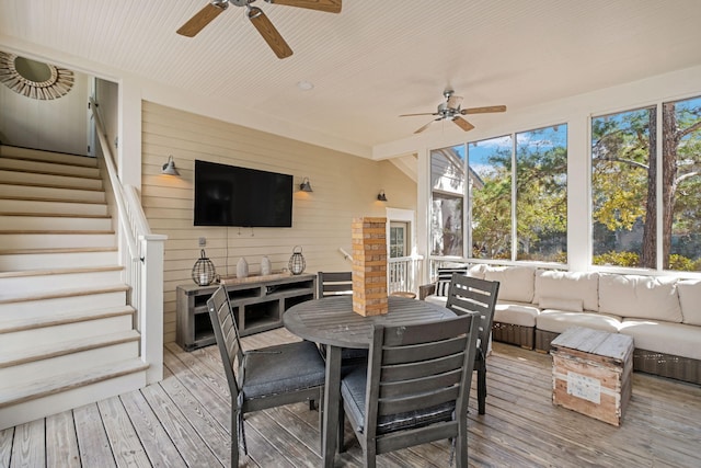 sunroom featuring ceiling fan