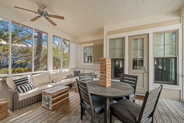 sunroom / solarium featuring ceiling fan