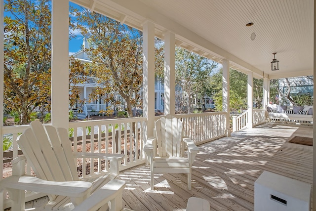 wooden terrace featuring covered porch