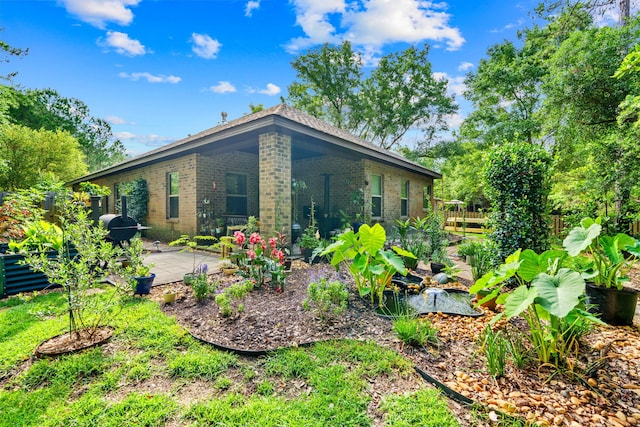 22 Camellia Ct, Freeport, FL 32439 - view of side of property featuring brick siding and a patio
