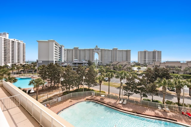 pool with a city view and fence