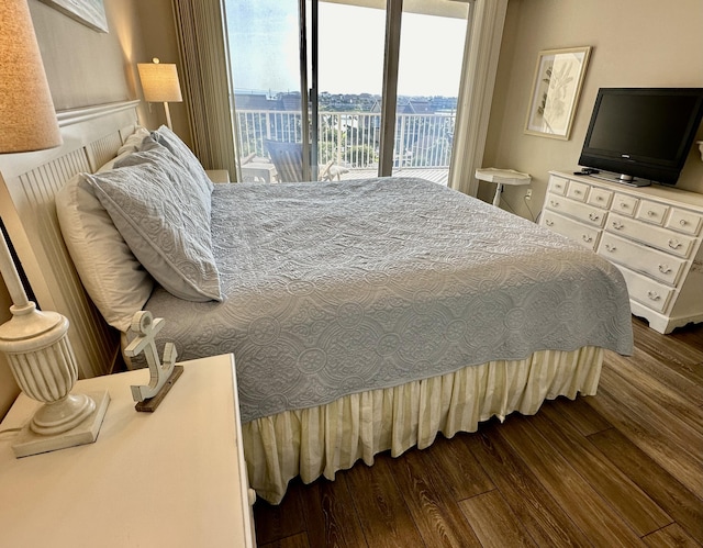 bedroom featuring access to outside and wood finished floors