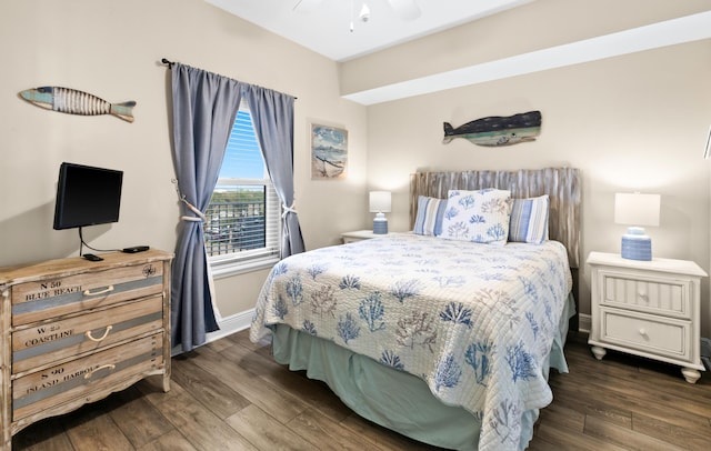 bedroom featuring ceiling fan, baseboards, and wood finished floors