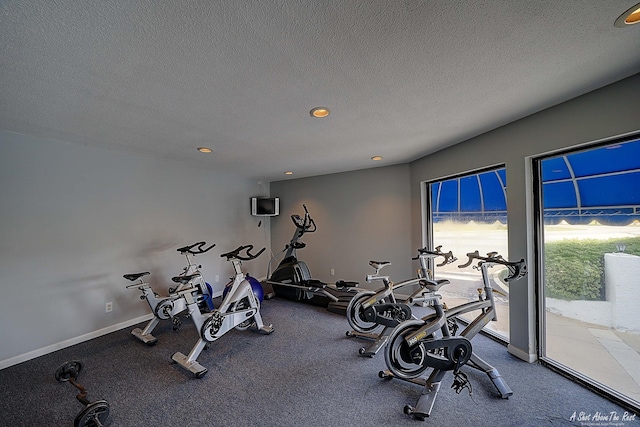 workout area featuring recessed lighting, baseboards, and a textured ceiling