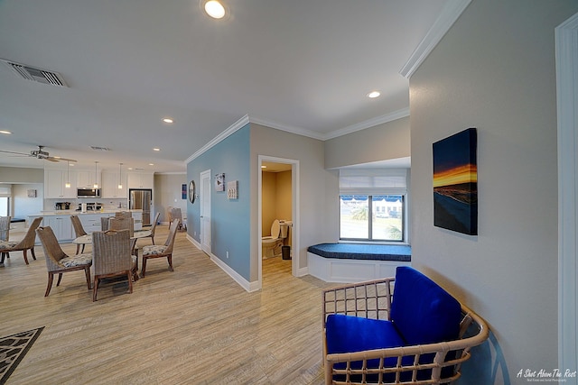 dining room with visible vents, baseboards, recessed lighting, light wood-style floors, and crown molding