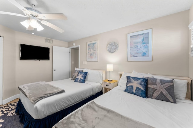 bedroom featuring visible vents, baseboards, and a ceiling fan