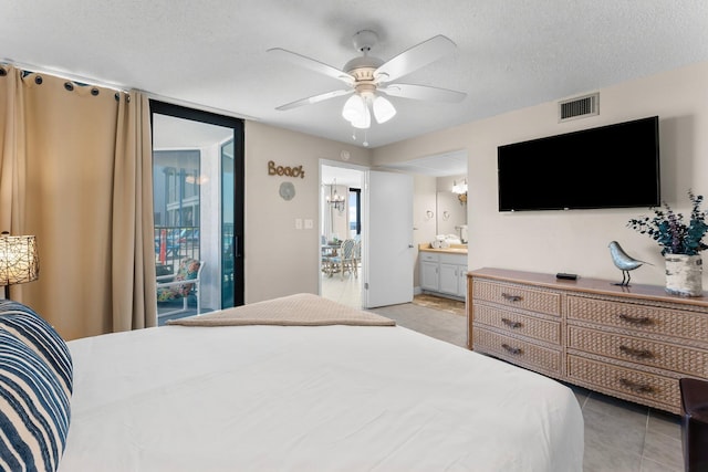 bedroom featuring light tile patterned floors, visible vents, ceiling fan, a textured ceiling, and connected bathroom