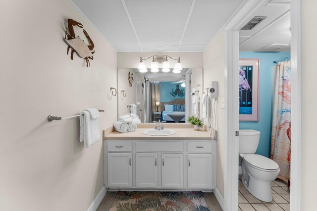 ensuite bathroom featuring vanity, visible vents, ensuite bath, tile patterned flooring, and toilet