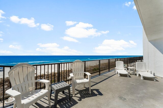 balcony with a view of the beach and a water view