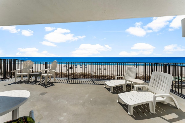 view of patio featuring a beach view and a water view