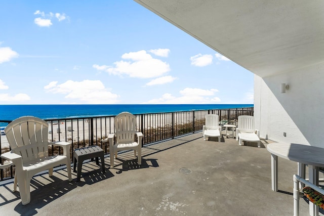 view of patio featuring a view of the beach and a water view