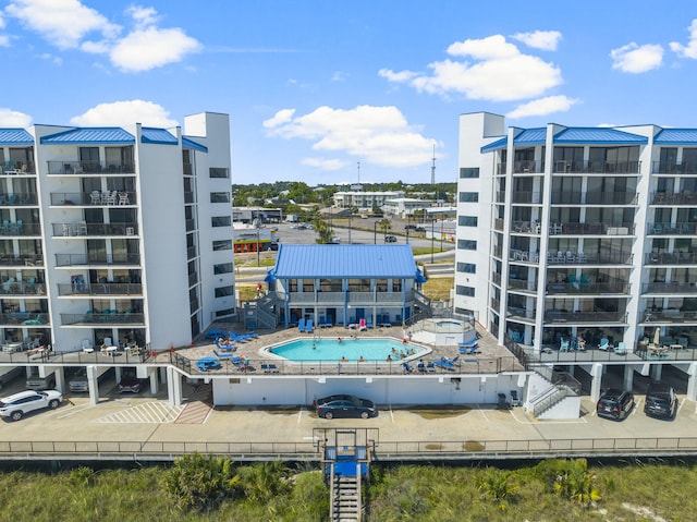 view of building exterior featuring a community pool