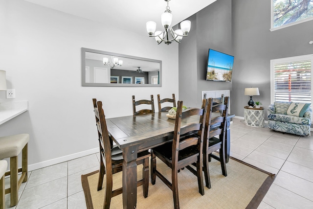 dining space featuring baseboards, plenty of natural light, an inviting chandelier, and light tile patterned flooring