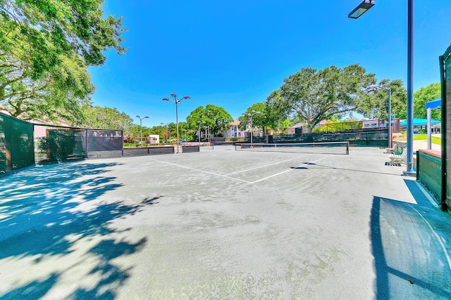 view of sport court featuring fence