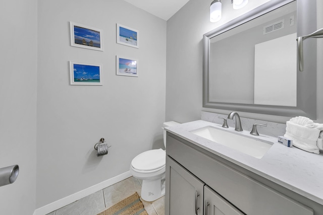 bathroom with vanity, baseboards, visible vents, tile patterned floors, and toilet