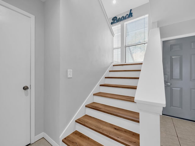 stairway featuring tile patterned floors