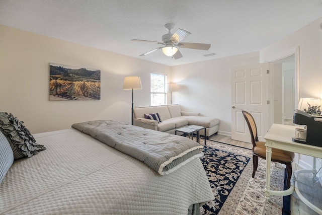 bedroom with ceiling fan, visible vents, and light wood-style flooring