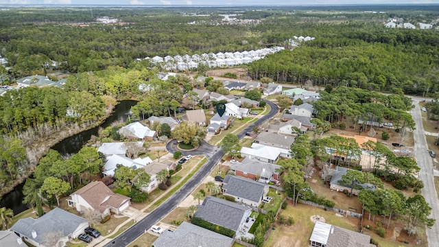 birds eye view of property featuring a forest view and a residential view