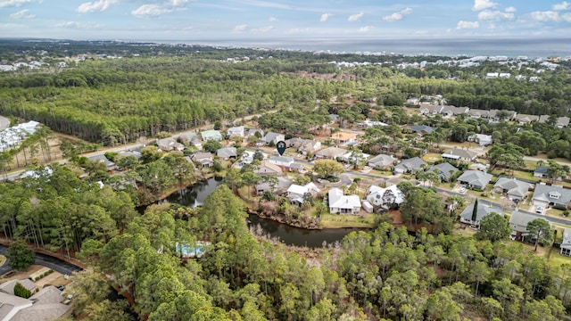 bird's eye view with a forest view, a water view, and a residential view