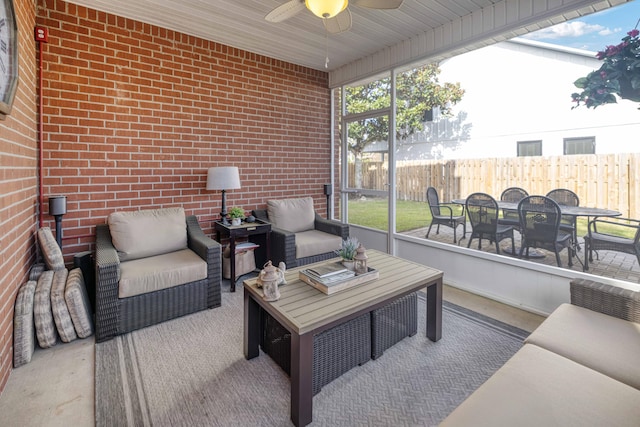 sunroom / solarium featuring a ceiling fan