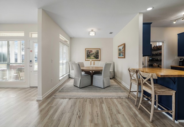 dining area with wood finished floors and baseboards