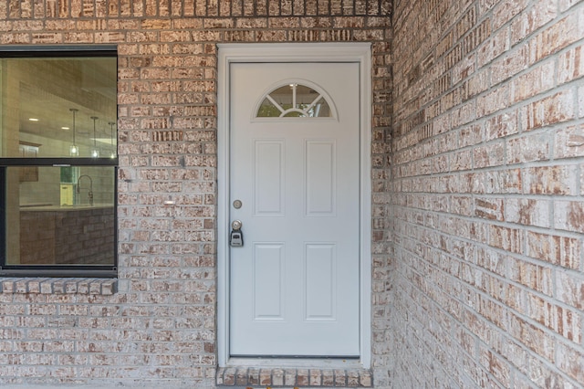 entrance to property with brick siding