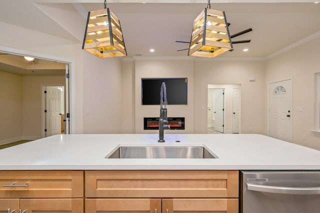 kitchen with ornamental molding, a sink, light countertops, stainless steel dishwasher, and open floor plan