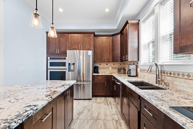 kitchen with tasteful backsplash, crown molding, light stone countertops, stainless steel appliances, and a sink