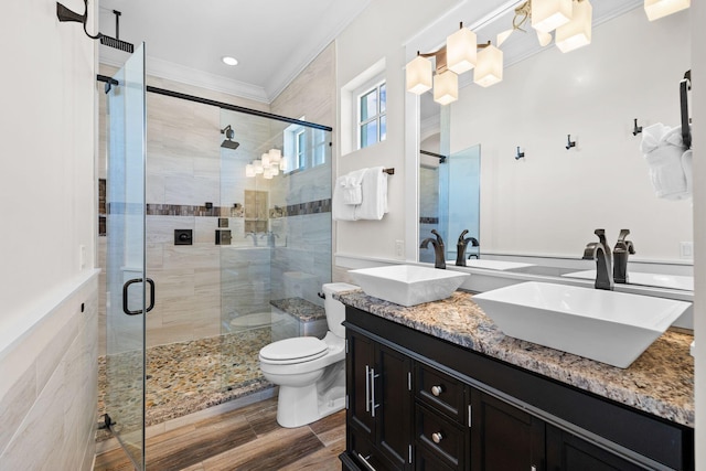 full bath with double vanity, ornamental molding, a stall shower, and a sink