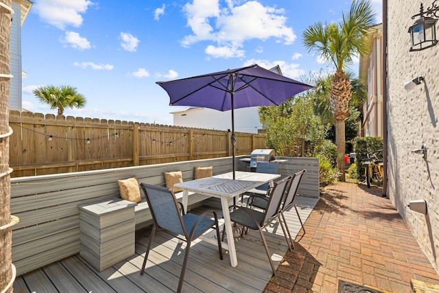 deck featuring outdoor dining space and fence