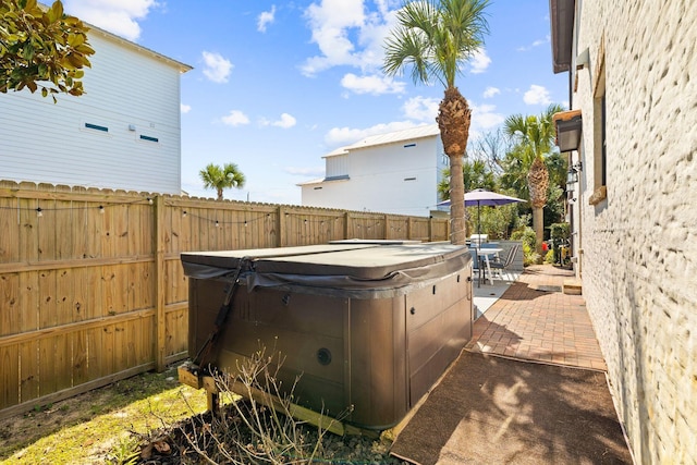 view of yard featuring a patio area, a hot tub, and a fenced backyard