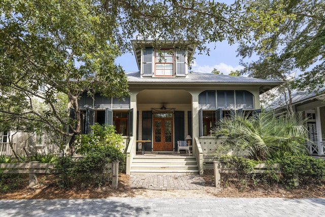 view of front of house featuring a porch, french doors, and stucco siding