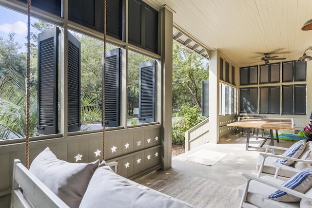 sunroom featuring wood ceiling, a wealth of natural light, and ceiling fan