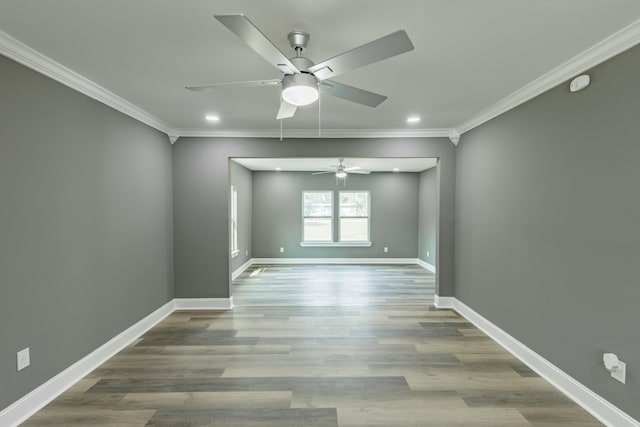 spare room featuring ornamental molding, a ceiling fan, wood finished floors, recessed lighting, and baseboards